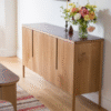 Modern minimalist wooden sideboard buffet with four seamless doors and integrated vertical recess handles by WoodBee Craft
