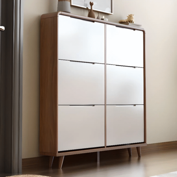 Modern wooden shoe cabinet by WoodBee Craft featuring six high-gloss white tipping bucket doors, rounded corners, and tapered legs in a bright hallway entryway.