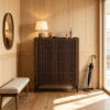 Premium slatted wooden shoe cabinet by WoodBee Craft in a dark walnut finish, featuring vertical wood screen doors and a lamp displayed on top in a bright entryway.