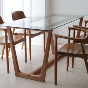 Modern minimalist glass top loop base dining table with light natural solid wood frame and matching curved armchairs by WoodBee Craft